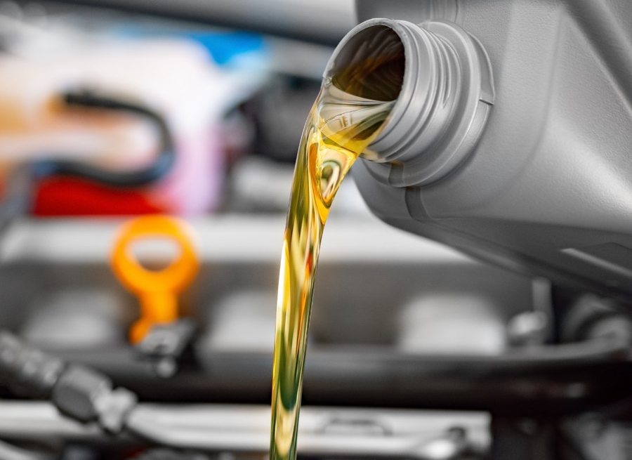 Oil being poured into a vehicle engine